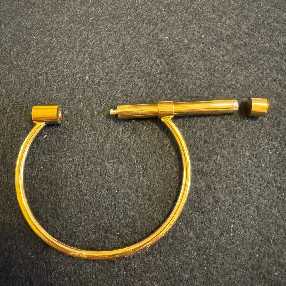 Gold tone D shaped cuff bracelet with screw closure